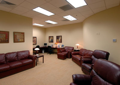 Interior picture of a comfortable waiting room lined with couches designed and built by McKee General Contractors.